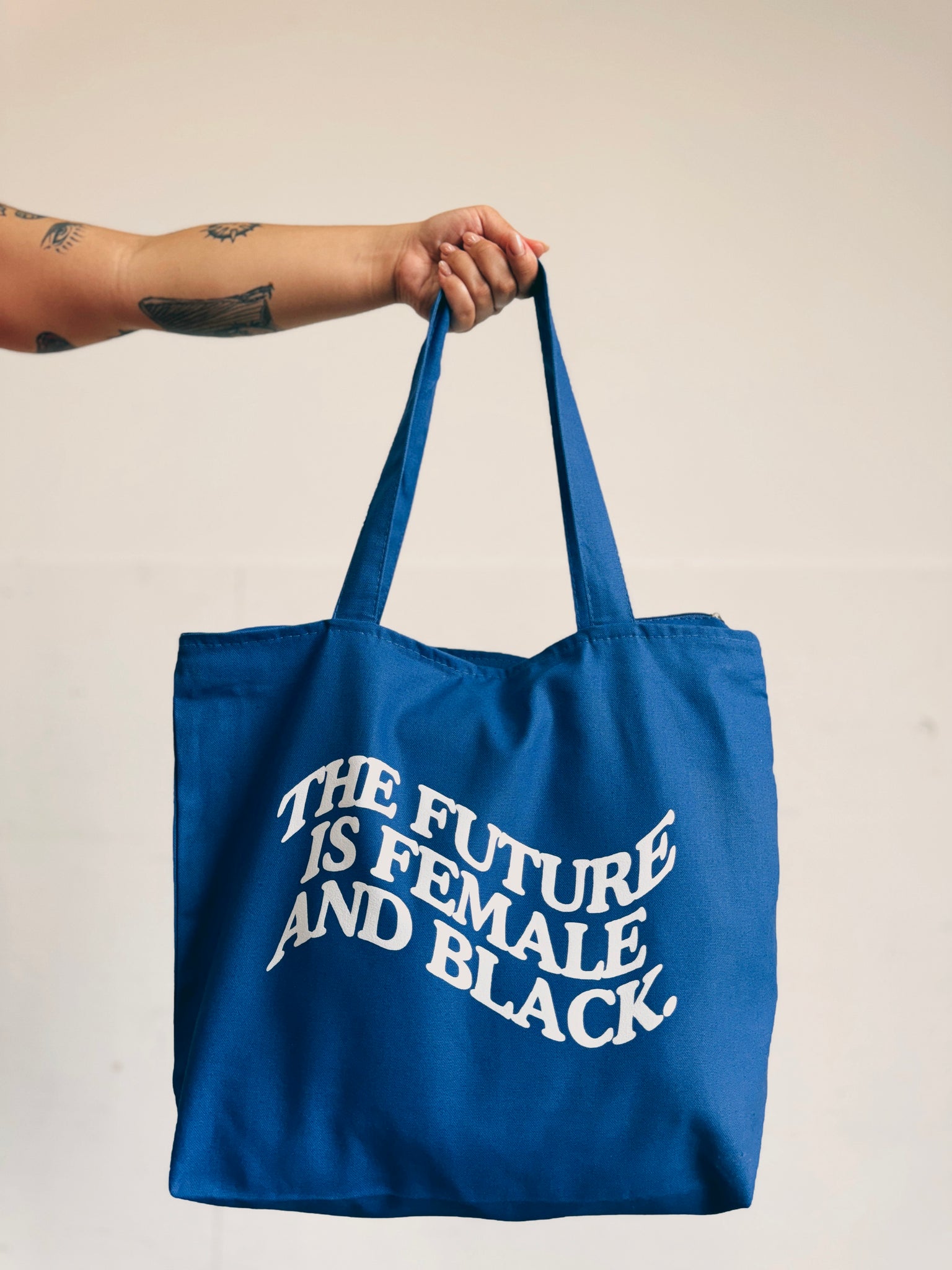 THE FUTURE IS FEMALE AND BLACK.® Tote Bag (more colors)