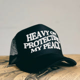 HEAVY ON PROTECTING MY PEACE Trucker Cap (More Colors)